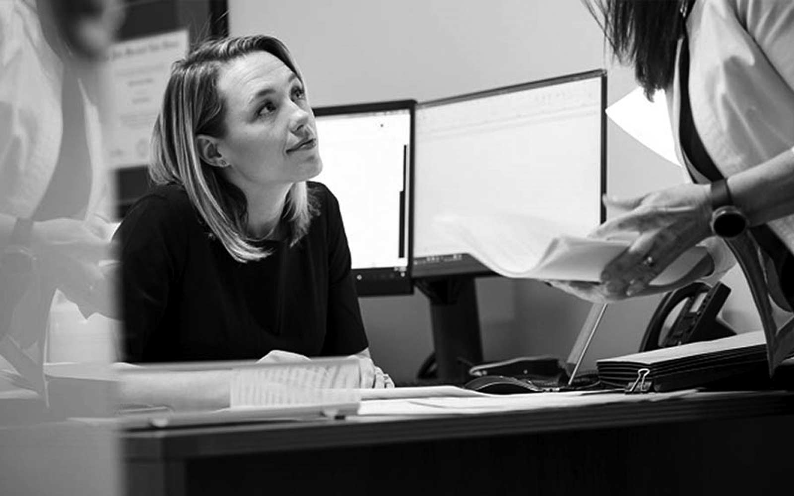 Kalli speaking with and associate